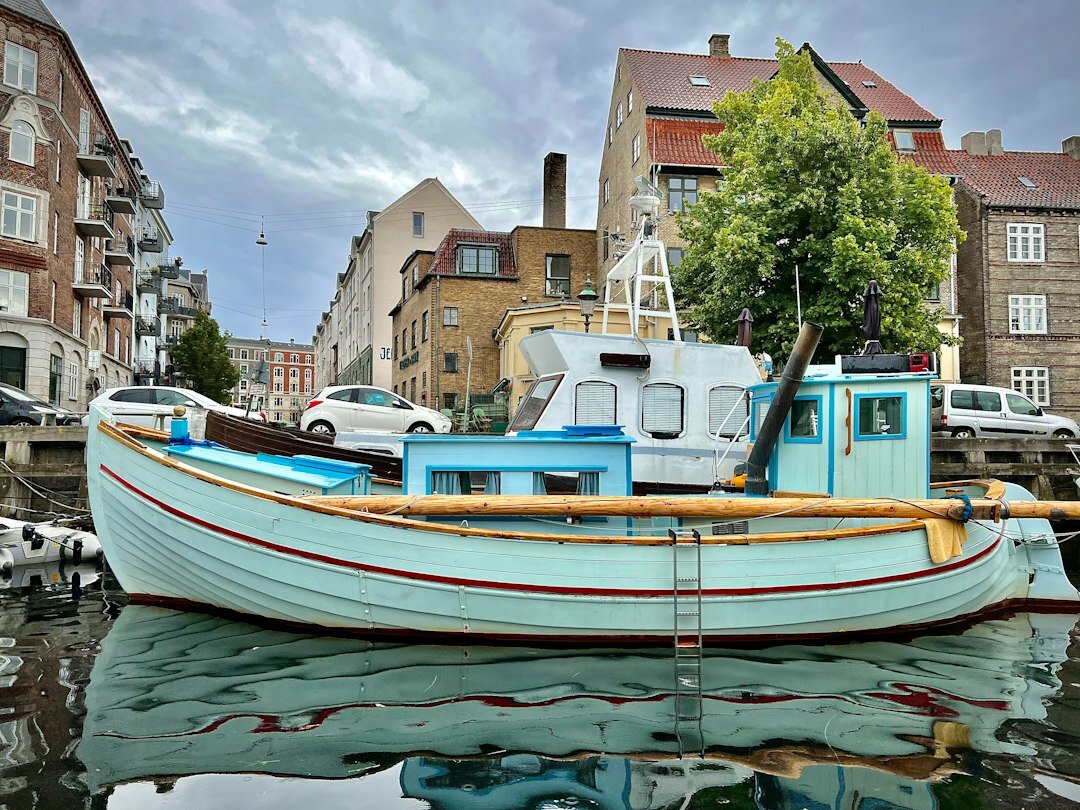 Photographer taking a portrait of an elderly Danish fisherman on a boat
