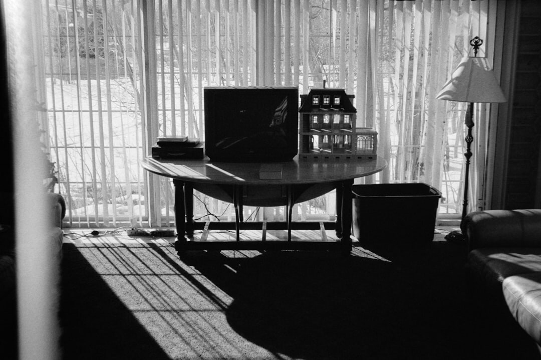 Close-up of an archive of printed documentary photographs and negatives on a wooden table