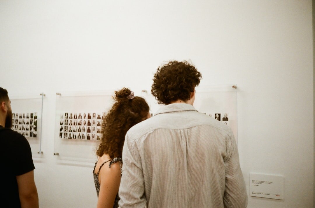 Visitors viewing a documentary photography exhibition on a gallery wall